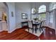 Dining room features hardwood floors, a high ceiling, lots of light, and a table for four at 1676 Bear Crossing Cir, Apopka, FL 32703
