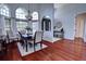 Dining room with wood floors and a high ceiling includes large windows and an elegant chandelier at 1676 Bear Crossing Cir, Apopka, FL 32703