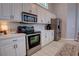 The well-equipped kitchen includes stainless steel appliances, white cabinetry, and a tiled backsplash for a modern look at 1676 Bear Crossing Cir, Apopka, FL 32703