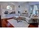 Open-concept living room with hardwood floors, high ceilings, and natural light flowing to the kitchen at 1676 Bear Crossing Cir, Apopka, FL 32703