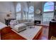 Bright living room boasts large windows, fireplace, and comfortable seating, perfect for relaxing or entertaining guests at 1676 Bear Crossing Cir, Apopka, FL 32703