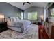 Serene main bedroom boasts high ceilings, natural light, and stylish furnishings for a peaceful retreat at 1676 Bear Crossing Cir, Apopka, FL 32703