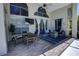 Covered patio with stylish furniture, ceiling fan, and large windows, perfect for outdoor living at 1676 Bear Crossing Cir, Apopka, FL 32703