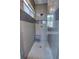 Modern bathroom with a walk-in shower featuring gray tiles, glass enclosure, and a stylish shower head and bench at 1676 Bear Crossing Cir, Apopka, FL 32703