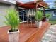 Relaxing back deck with wood pergola, outdoor seating, and potted plants at 1919 E South St, Orlando, FL 32801