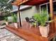 Exterior wooden deck with patio furniture, plants and stone pavers, adjacent to house at 1919 E South St, Orlando, FL 32801