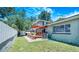 The backyard shows a wood pergola and deck with lush green grass and white privacy fence at 1919 E South St, Orlando, FL 32801