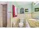 Bathroom featuring a granite countertop, updated fixtures, and decorative mirrors in neutral color palette at 1919 E South St, Orlando, FL 32801