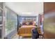 A bright bedroom featuring a wood-framed bed, tiled floor, and multiple windows for natural light at 1919 E South St, Orlando, FL 32801