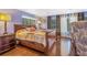 Comfortable bedroom featuring hardwood floors, natural light, and a well-appointed nightstand at 1919 E South St, Orlando, FL 32801