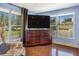 Bright bedroom featuring a large dresser with TV, natural light, and seating area with comfortable arm chair at 1919 E South St, Orlando, FL 32801