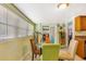 Bright dining area featuring a glass table, colorful chairs, and natural light from the large window at 1919 E South St, Orlando, FL 32801