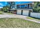 Charming two-story home with a brick accent, a two car garage, and a well-manicured lawn at 1919 E South St, Orlando, FL 32801