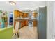 Well-equipped kitchen featuring wood cabinets, stainless steel appliances, and an adjacent dining area at 1919 E South St, Orlando, FL 32801