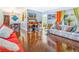 Well-lit living room with hardwood floors, comfortable seating, and a view into the dining area at 1919 E South St, Orlando, FL 32801