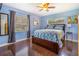 This beautiful bedroom features a blue color scheme, ceiling fan and dark hardwood floors at 1919 E South St, Orlando, FL 32801