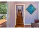 Staircase with hardwood steps, adjacent to a dining area and leading to the upper level of the home at 1919 E South St, Orlando, FL 32801