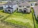 Aerial view of large homes with spacious fenced-in backyards and nearby lake at 200 Azure Mist Way, Daytona Beach, FL 32124