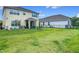 Wide open backyard with green grass, metal fence, and playset in the distance at 200 Azure Mist Way, Daytona Beach, FL 32124