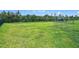 Fenced backyard with green grass and a playground in the distance at 200 Azure Mist Way, Daytona Beach, FL 32124