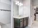 Bright bathroom with a vanity and a walk in shower, with white subway tile and a black accent row at 200 Azure Mist Way, Daytona Beach, FL 32124