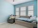 Bedroom with a tufted daybed, a window with white shutters and carpeting at 200 Azure Mist Way, Daytona Beach, FL 32124