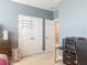 Neutral bedroom featuring double closets, blue accent wall, and carpet flooring at 200 Azure Mist Way, Daytona Beach, FL 32124