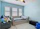 room with a tufted daybed and window with white shutters and carpeting at 200 Azure Mist Way, Daytona Beach, FL 32124