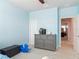 Blue bedroom featuring a grey dresser and decor with a view of a walk-in closet at 200 Azure Mist Way, Daytona Beach, FL 32124