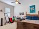 Bedroom with dark wood bed and ceiling fan, plus decor and a window with blinds at 200 Azure Mist Way, Daytona Beach, FL 32124