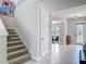 Bright entryway with tile floors, staircase, and a view into the adjacent home gym at 200 Azure Mist Way, Daytona Beach, FL 32124