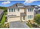 Charming two-story home featuring a two-car garage, neat landscaping, and a welcoming front porch at 200 Azure Mist Way, Daytona Beach, FL 32124