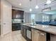 Spacious kitchen island with stainless steel dishwasher, stylish granite counters, and dark cabinetry at 200 Azure Mist Way, Daytona Beach, FL 32124