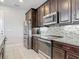 Updated kitchen with granite counters, stainless steel appliances, and dark wood cabinetry at 200 Azure Mist Way, Daytona Beach, FL 32124
