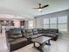 Spacious living room with a large sectional couch, adjacent to the dining and kitchen areas at 200 Azure Mist Way, Daytona Beach, FL 32124