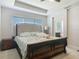 Spacious main bedroom with a tray ceiling, carpet floors, and ensuite bathroom access at 200 Azure Mist Way, Daytona Beach, FL 32124