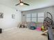 Bright playroom with a ceiling fan, a window with shutters, and play equipment at 200 Azure Mist Way, Daytona Beach, FL 32124