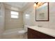 Bathroom features tiled tub, vanity, mirror, and good lighting at 2013 Dearing Ave, Deltona, FL 32725