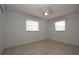 Bright bedroom featuring tile flooring and two windows for natural light at 2013 Dearing Ave, Deltona, FL 32725