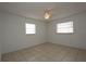 Cozy bedroom featuring tiled floors, neutral walls, and two windows letting in natural light at 2013 Dearing Ave, Deltona, FL 32725