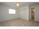 Bright bedroom with tile flooring, ceiling fan, closet, and adjacent bathroom at 2013 Dearing Ave, Deltona, FL 32725