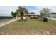 Inviting single-Gathering home with a large front yard, mature palm tree, and driveway at 2013 Dearing Ave, Deltona, FL 32725
