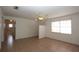 Spacious living room with tiled floors, ceiling fan, window overlooking the front yard, and neutral walls at 2013 Dearing Ave, Deltona, FL 32725