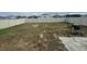 Backyard features a grill, new fence, and an unfinished lawn ready for personal touches at 268 Fiddlewood Ct, Davenport, FL 33837