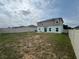 Backyard view features a fence, home and lawn waiting for creative personal touches at 268 Fiddlewood Ct, Davenport, FL 33837