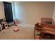 Bedroom features carpet flooring, neutral paint, and crib with toys, and kitchen at 268 Fiddlewood Ct, Davenport, FL 33837
