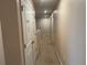 Hallway features carpet flooring, neutral paint and white doors leading to rooms at 268 Fiddlewood Ct, Davenport, FL 33837