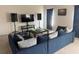Living room featuring a large blue couch, speakers and TV at 268 Fiddlewood Ct, Davenport, FL 33837