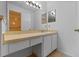Bathroom vanity with a makeup area, white cabinets, and a view to the toilet and shower at 2750 King Oak Cir, St Cloud, FL 34769