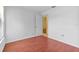Empty bedroom with wood-look flooring, white walls, and a window providing natural light at 2750 King Oak Cir, St Cloud, FL 34769